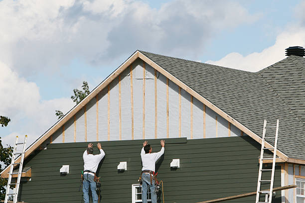 Professional Siding technician working in Norwood, MA